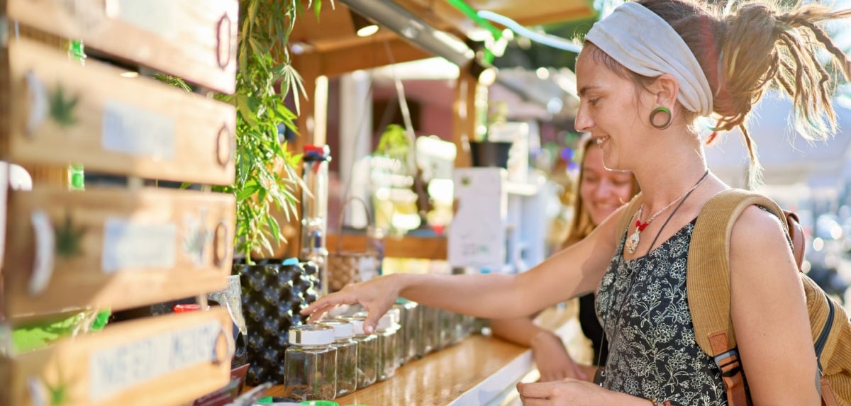 Woman browsing a cannabis dispensary's marijuana products Woman browsing a cannabis dispensary's marijuana products