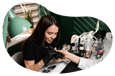 Nail technician working on a client's hand.