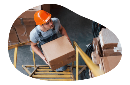A worker putting away inventory in a warehouse A worker putting away inventory in a warehouse